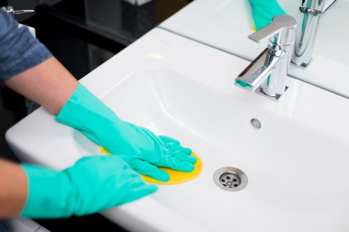 Professional cleaner preparing a Belgravia home with careful attention