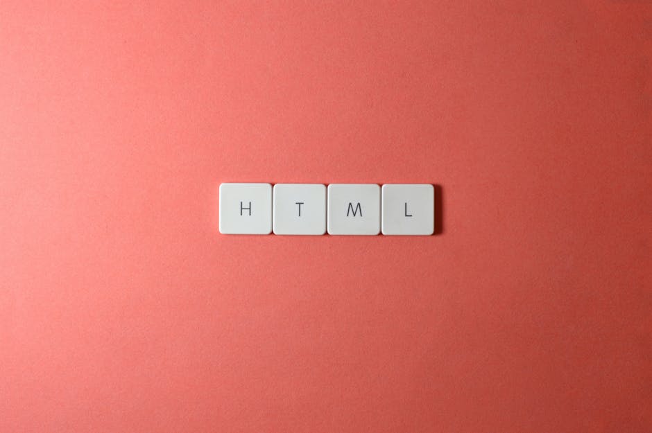 Close-up of four white rectangular tiles with black letters spelling 'HTML', arranged in a straight line on a pink background. The tiles are evenly spaced and appear clean, with soft lighting highligh